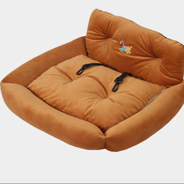 Brown pet bed with a plush cushion on a light gray background